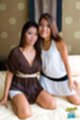 Girlfriends kneeling on bed